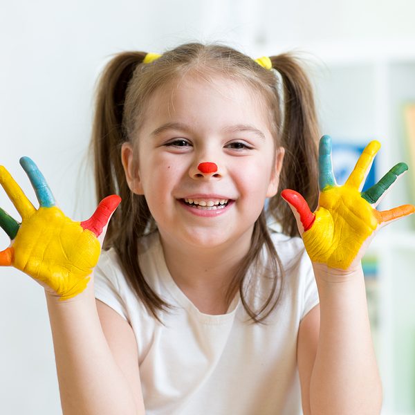 cute cheerful child with painted hands and face